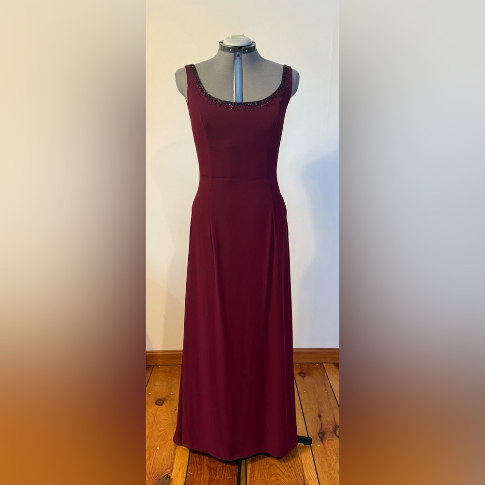 Burgundy beaded sleeveless formal dress with wide cut back with ruching. Size 14